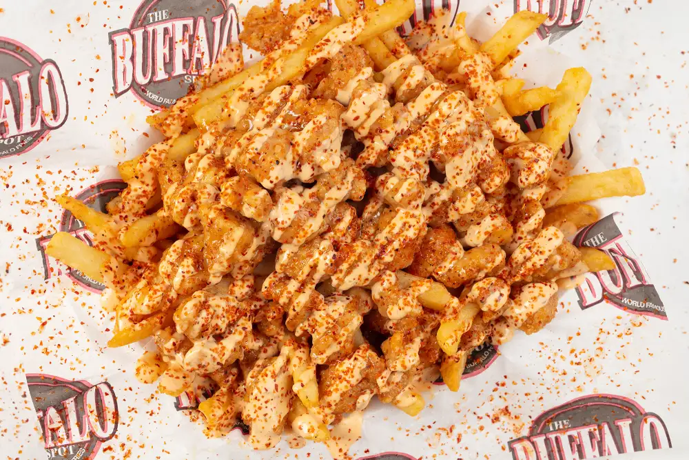 Fully dressed buffalo fries with sauce and seasoning