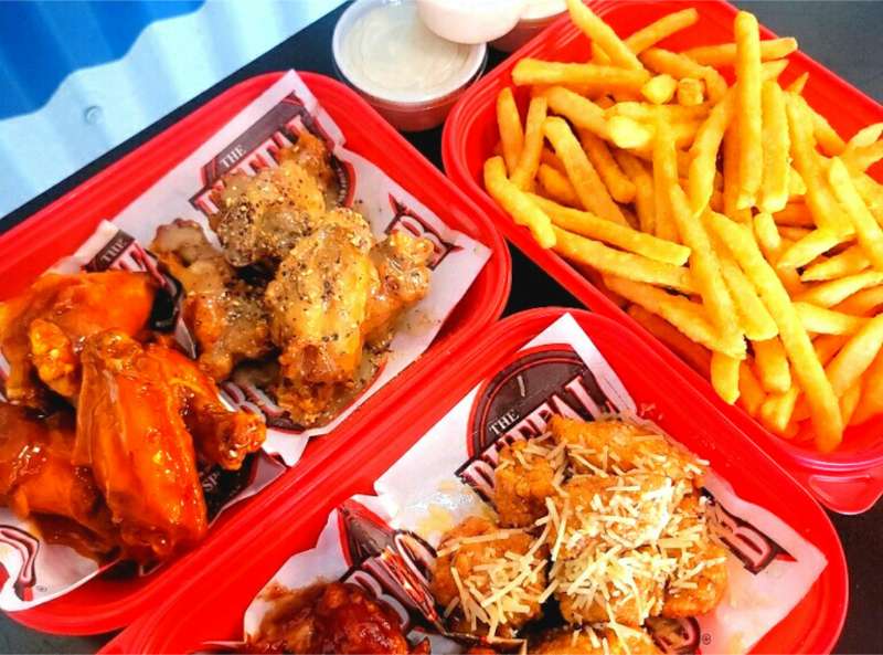 an array of wings and fries from The Buffalo Spot
